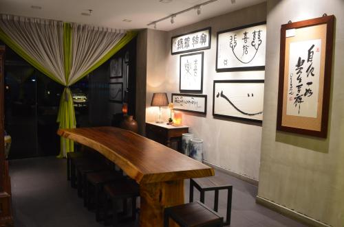 a dining room with a table and some writing on the wall at Cozy Living Sky Apartment in Kota Kinabalu