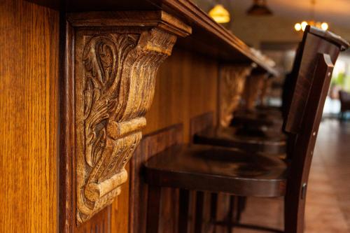 a row of wooden tables and chairs in a restaurant at Penzion BERG in Bratislava