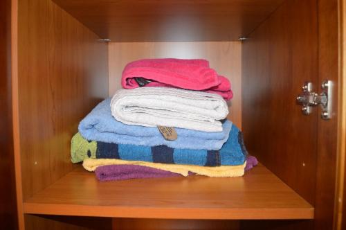 a pile of towels are stacked in a closet at Perfect Airport Apartments in Dublin