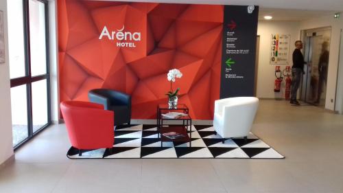 a lobby with two chairs and a checkerboard floor at Hotel Arena Toulouse in Toulouse
