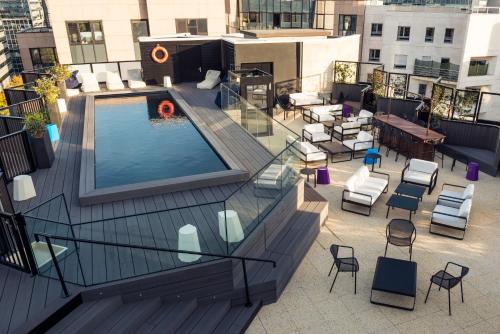 an overhead view of a rooftop patio with a pool on a building at Mercure Paris Boulogne in Boulogne-Billancourt