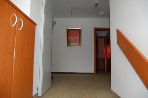 a hallway with a white wall and a picture on the wall at Penzion Pri Slovenc in Dol pri Ljubljani