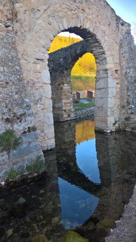an old stone bridge with two arches over a river at Antichi Feudi Dimora D'Epoca in Teggiano