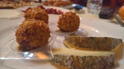 a white plate with some food on a table at Antichi Feudi Dimora D'Epoca in Teggiano