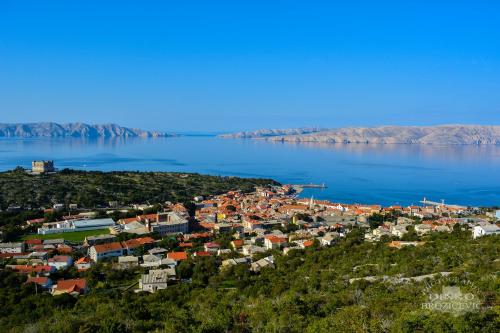 a small town on the shore of a body of water at Apartment Skale in Senj