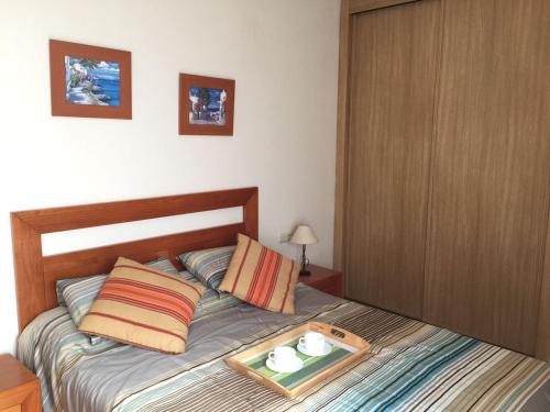 a bedroom with a bed with a tray on it at Oliastur Cotillo Apartament in Cotillo