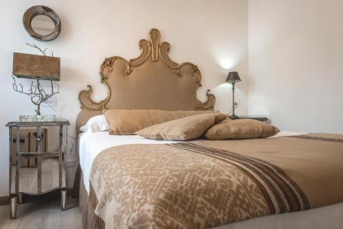 a bedroom with a bed with a large headboard at Locanda Senio in Palazzuolo sul Senio