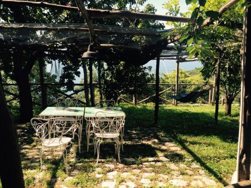 a table and chairs sitting under a pergola at Casa Flora in Vietri sul Mare