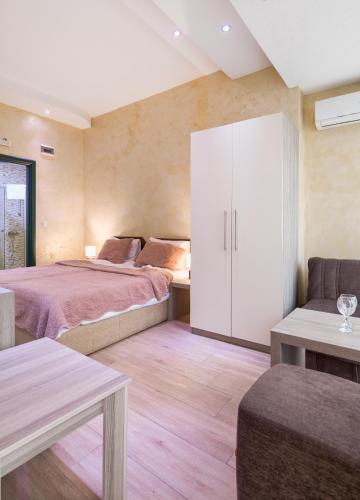 a bedroom with two beds and a white cabinet at Hotel Green Center Gili in Gostivar