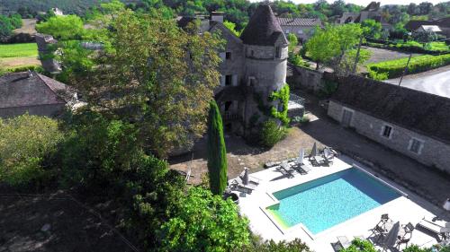 an aerial view of a castle with a swimming pool at Mas de Garrigue in Calvignac