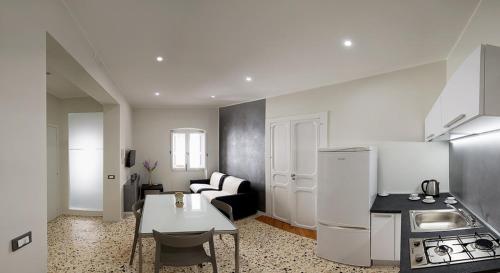 a kitchen with a white refrigerator and a table at Residenza Savianna in Sciacca