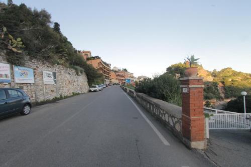 an empty street with a car parked on the side of a road at Taormina Isola Bella Apartment - Taormina Holidays in Taormina