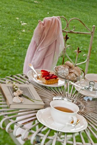 a table with plates of food and a cup of coffee at Relais Del Maro in Borgomaro
