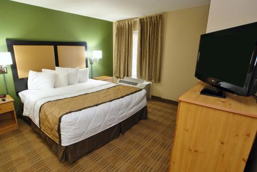 a hotel room with a bed and a flat screen tv at Extended Stay America Suites - Nashville - Airport - Music City in Nashville