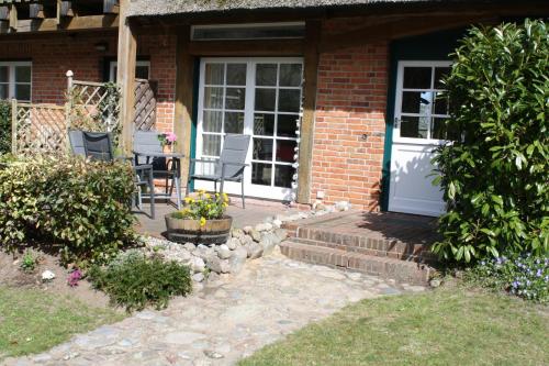 a brick house with a door and a patio at Reethus Stöfs in Behrensdorf