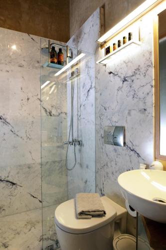 a bathroom with a toilet and a sink at La Casa Piccola in Chania