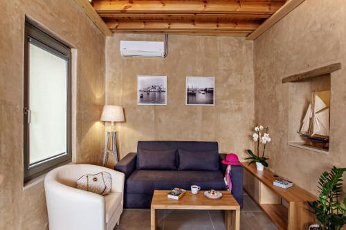 a living room with a couch and a table at La Casa Piccola in Chania