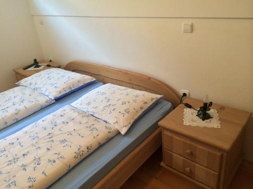 a bedroom with a bed and a nightstand with a bed sidx sidx at Apartments Pod macesnovo streho in Solčava