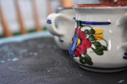 two cups on a table with flowers on them at Agiasos Tranditional House in Agiásos