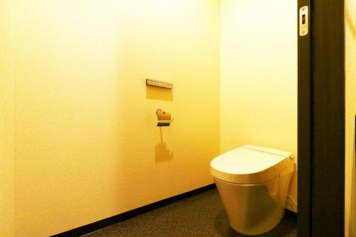 a bathroom with a toilet in a stall at Ryokan Karasawa in Kanazawa