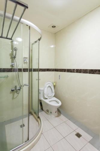 a bathroom with a toilet and a glass shower at Eureka in Tainan