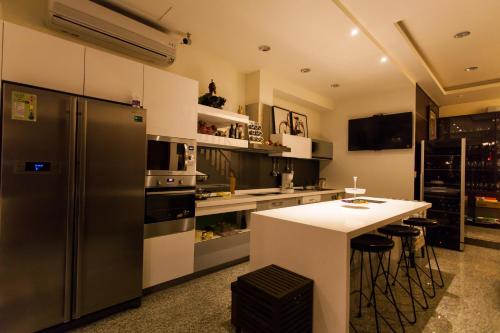 a kitchen with a stainless steel refrigerator and a counter at Eureka in Tainan