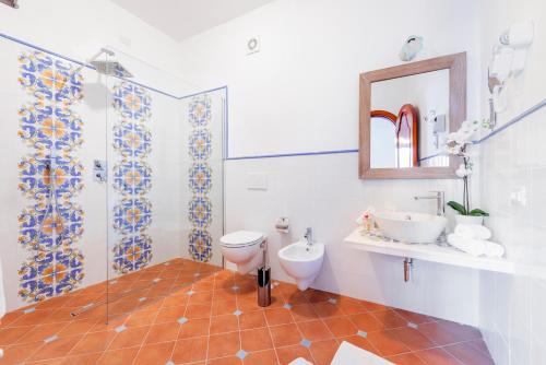 a bathroom with a toilet and a sink and a mirror at Florida Residence in Positano