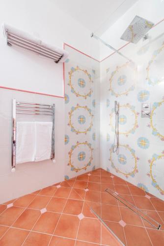 a bathroom with a shower and a tiled floor at Florida Residence in Positano