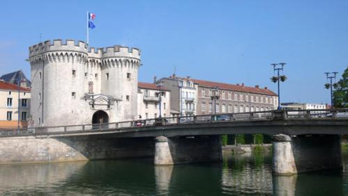 eine Brücke über einen Fluss mit einem Schloss in der Unterkunft Gite de la Princerie in Verdun-sur-Meuse