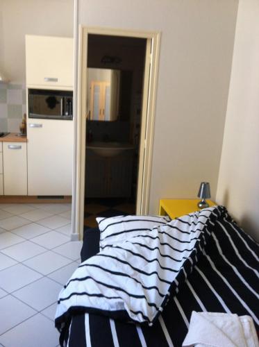 ヴェルダン・シュル・ムーズにあるGite de la Princerieのリビングルーム(ベッド1台付)、キッチンが備わります。