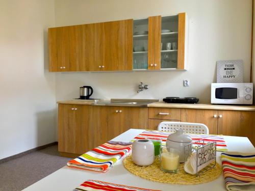 a small kitchen with a table with a microwave at Apartment Olomouc Centre in Olomouc