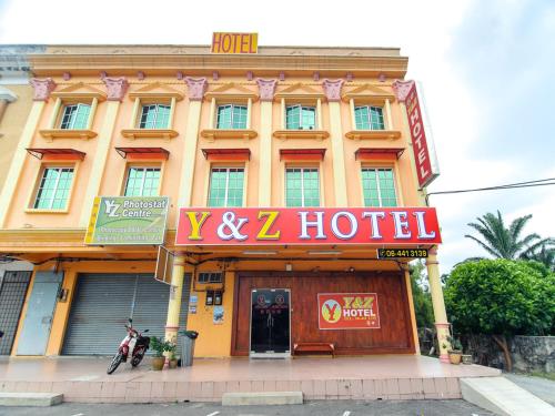 a hotel with a sign in front of a building at Y&Z Hotel in Melaka