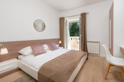 a bedroom with a bed and a desk and a window at Urban Chic LUXE apartments near Beach Bačvice & CENTRE in Split