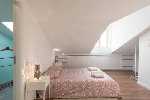 a white bedroom with a bed and a window at Charming Apartment Tram 28 in Lisbon