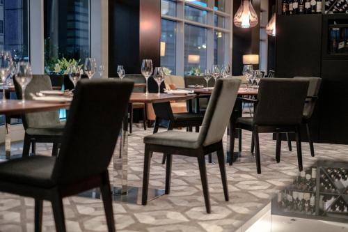 a dining room with a table and chairs and wine glasses at Andersia Hotel & Spa Poznan, a member of Radisson Individuals in Poznań