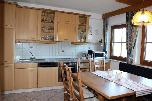 een keuken met een houten tafel en een eetkamer bij Ferienwohnung Eder in Hippach