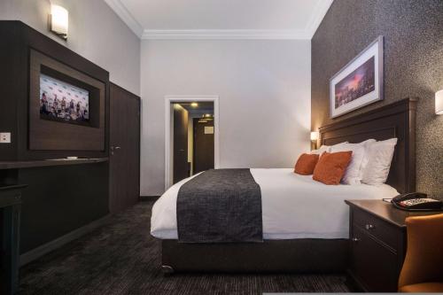 A bed or beds in a room at BON Hotel Abuja