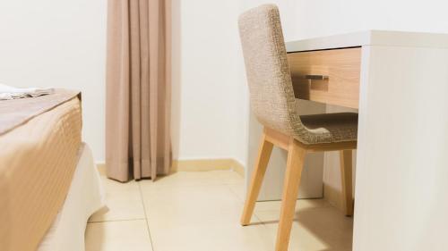 a chair sitting at a desk in a room at Apartamentos Costa Luz Punta Umbría in Punta Umbría