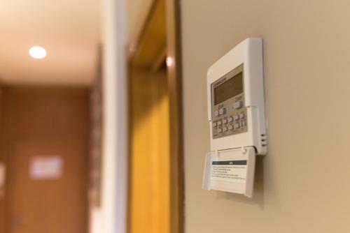 a phone is attached to a door at Apartamentos Costa Luz Punta Umbría in Punta Umbría