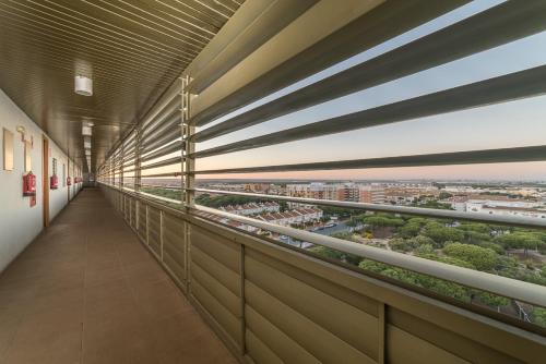 a corridor in a building with a view of a city at Apartamentos Costa Luz Punta Umbría in Punta Umbría