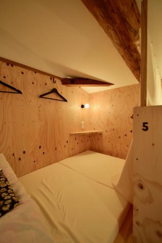 a small room with two beds in a attic at Saga International Guesthouse Hagakure in Saga