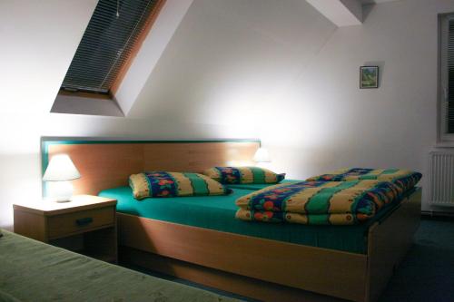 two beds in a bedroom with two pillows on them at Dziwnów Wczasowisko in Dziwnów
