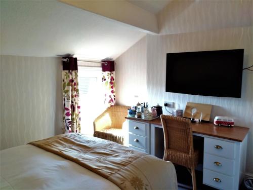 A television and/or entertainment center at Bay Tree House Southport 