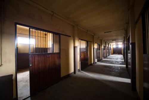 an empty hallway with a row of doors and windows at Agriturismo Tenuta "Il Cigno" in Villanterio