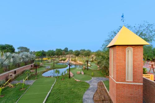 a view of a water park with a tower at Gulmohar Greens Golf & Country Club in Sānand