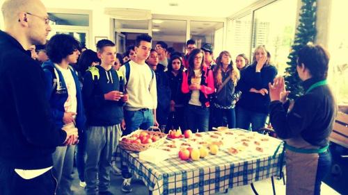 a group of people standing around a table with a cake at Agritur Leita in Tuenno