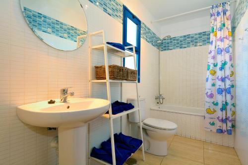 Un baño con lavabo, inodoro y espejo. en Top Charco San Gines Stunning View Lanzarote By PVL, en Arrecife
