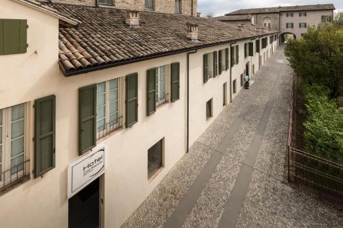 an empty street in a village with buildings at Hotel Cortaccia Sanvitale in Sala Baganza