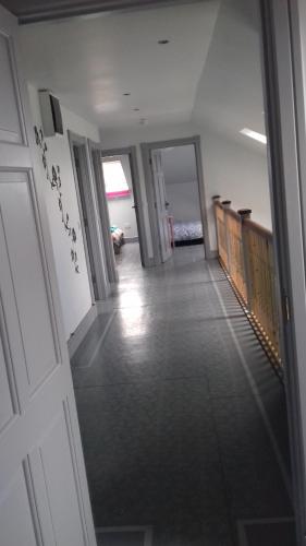 a hallway of a building with a door and a room at Lus Mor in Roundwood