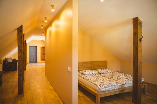two images of a bedroom with a bed and a hallway at Ventspils Rātslaukuma apartamenti in Ventspils